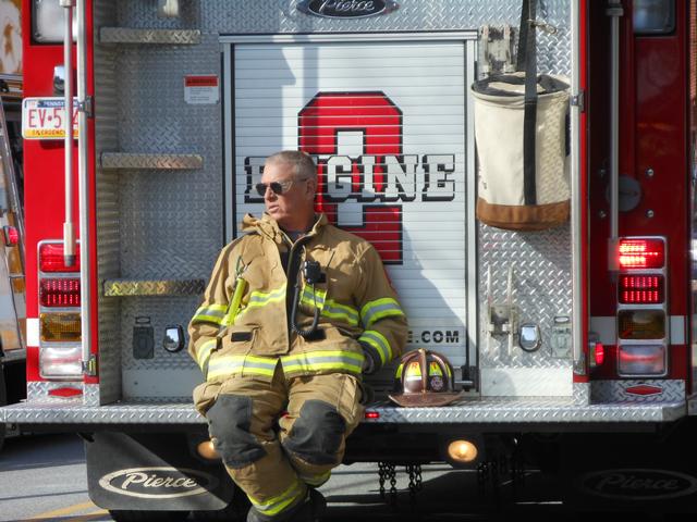 Chief Emeritus Rich Terry sits on the back step of Engine 21-2 at a West Grove house fire.